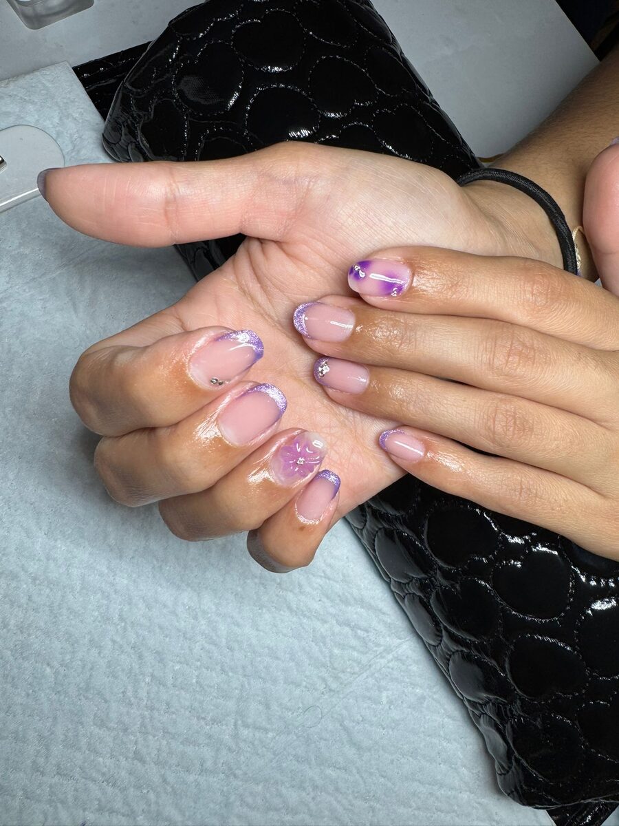 Uñas naturales con acento morado y flor